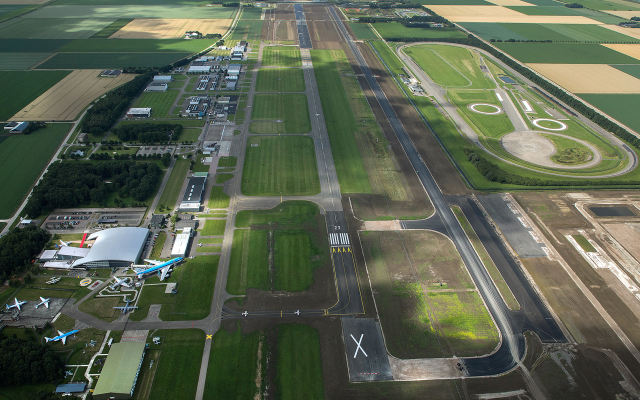 Lelystad Airport (EHLE) from the air with its runway, hangars and the Aviodrome, home base of every sightseeing flight over the Netherlands
